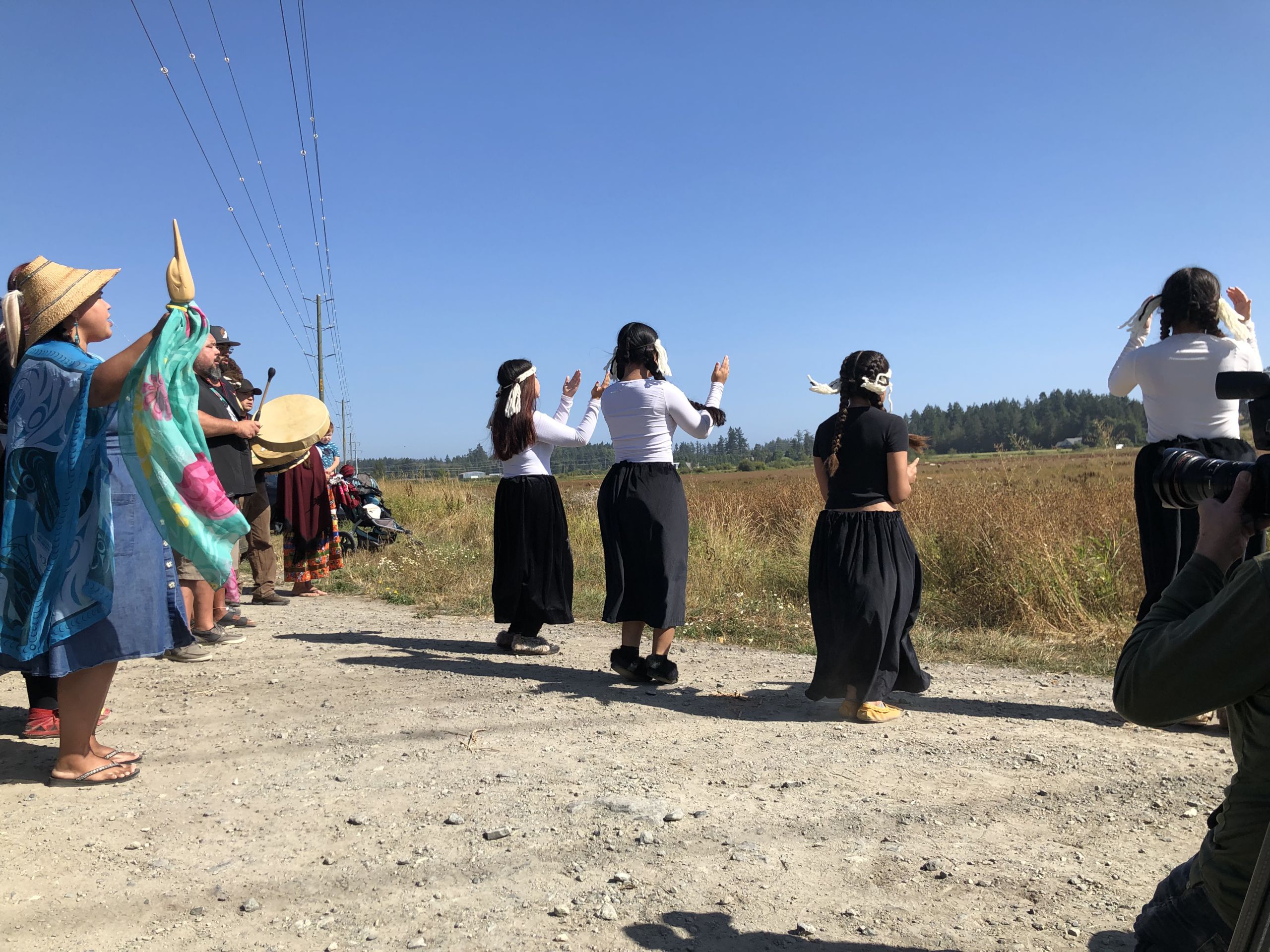 W̱SÁNEĆ Community Members engaging in Cultural Protocol at land return ceremony at ȾIKEL